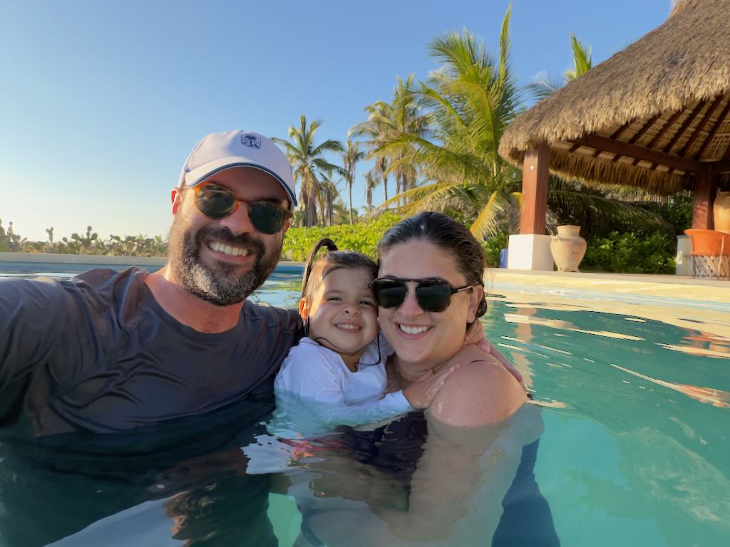 Family in the pool under a clear sky