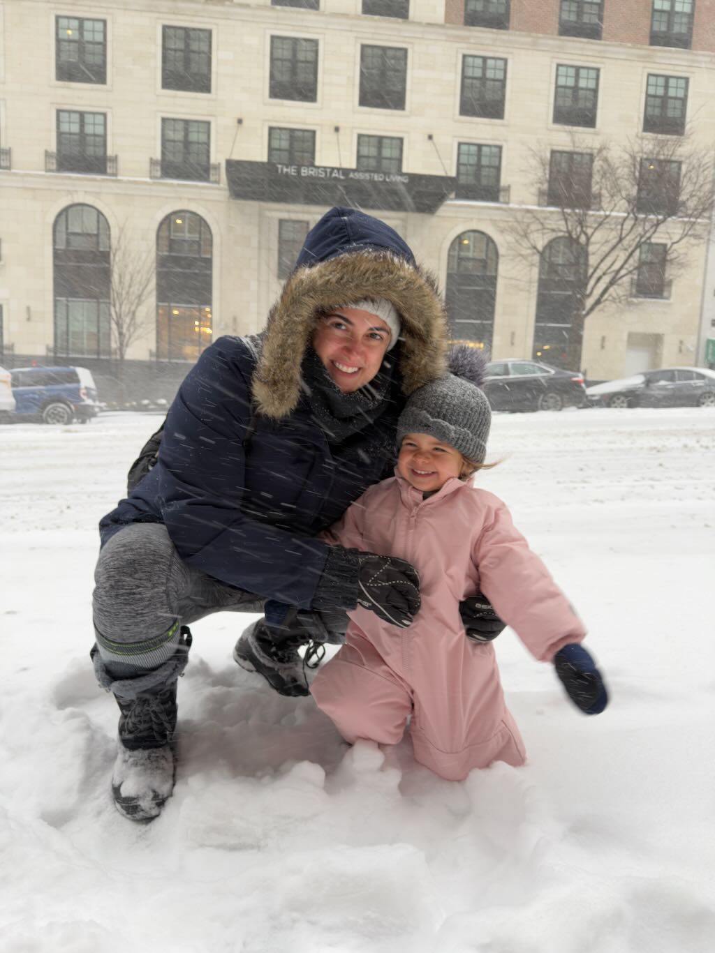 Mom and daughter playing in the snow